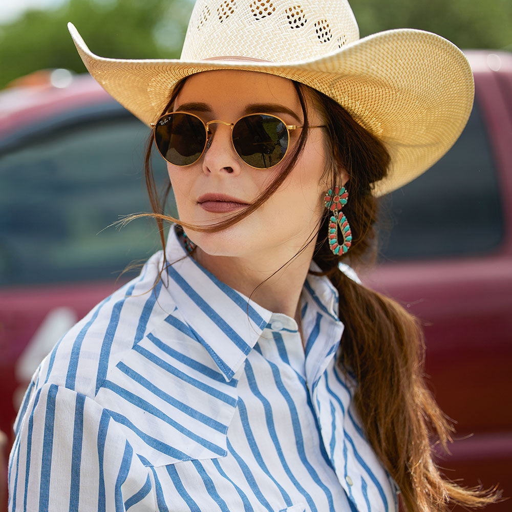 Jenna Paulette wearing a cowboy hat and sunglasses.