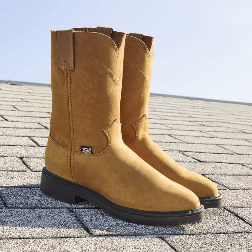 The Conductor 10" Work Boots in hazel brown on top of a shingled roof.