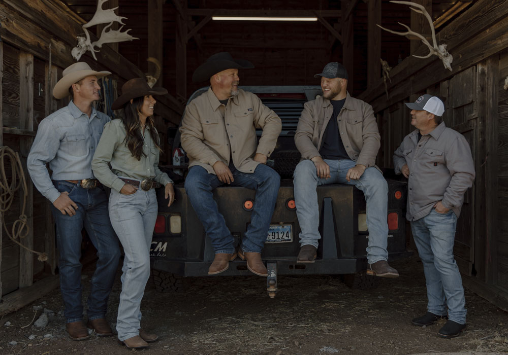 A group of men and a woman wearing Justin Boots, Justin Jeans, Justin Shirts and Justin hats.