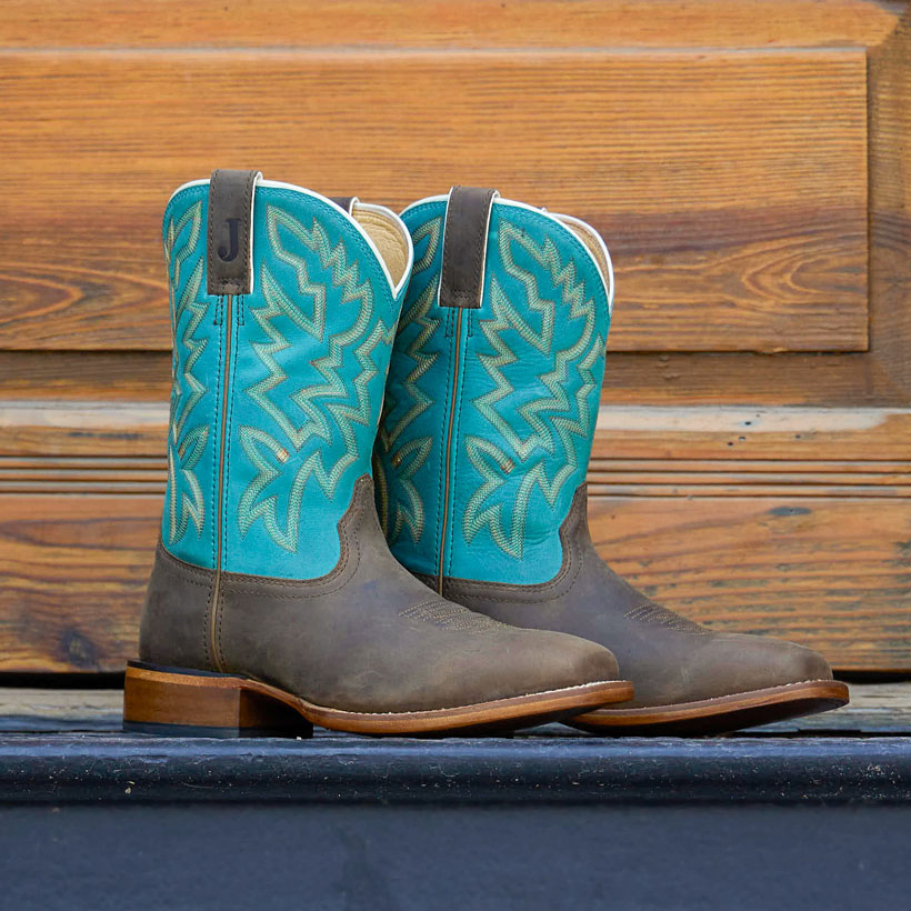 The Jackpot 11" Western boots in Aged Bark (Brown) sitting in front of a wood door.