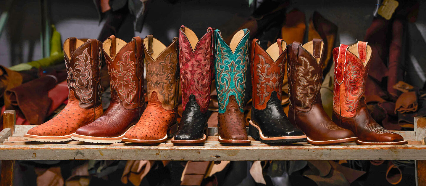A fan image of AQHA-styled boots posed in front of different types of boot leathers.