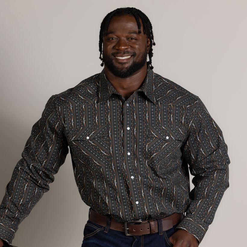 A man wearing the Hj Justin & Son Snap Shirt in black stripe pattern.