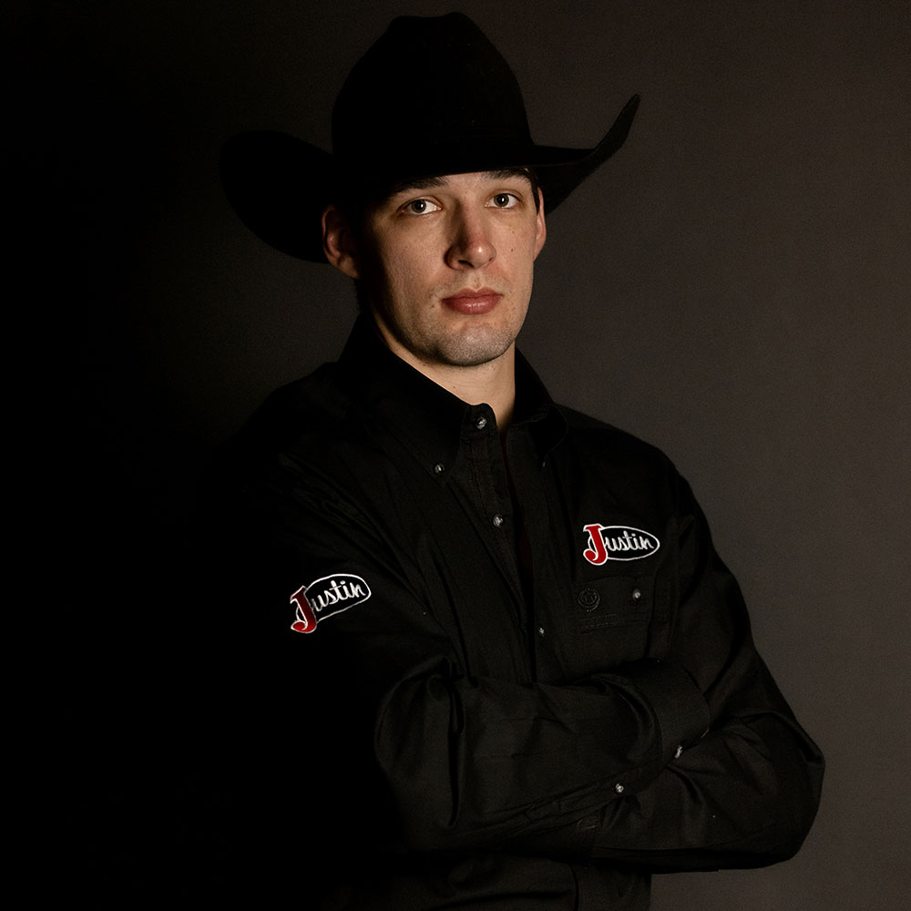 Jess Pope wearing a black shirt and cowboy hat.