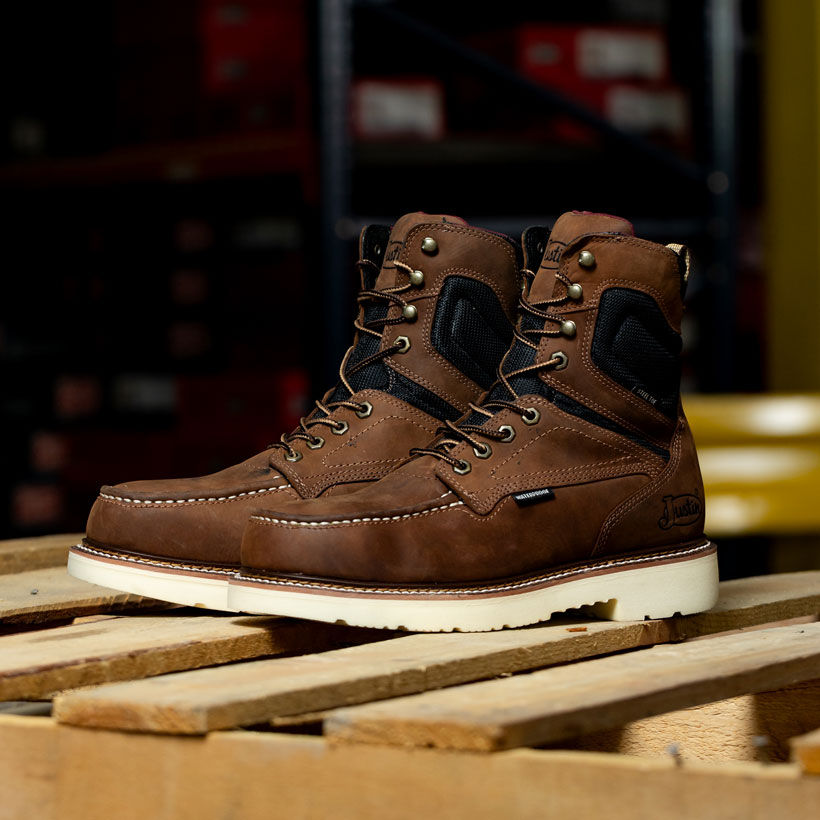 The Ledbetter 8" Waterproof boots in brown sitting on a wood pallet.