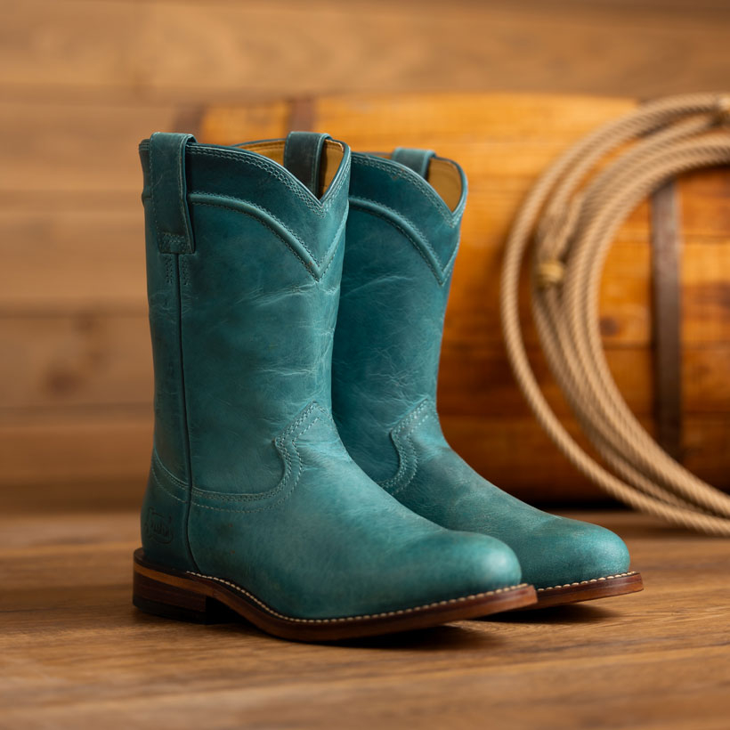 The Holland 10" Roper in Turquoise (Blue) on a wood floor.