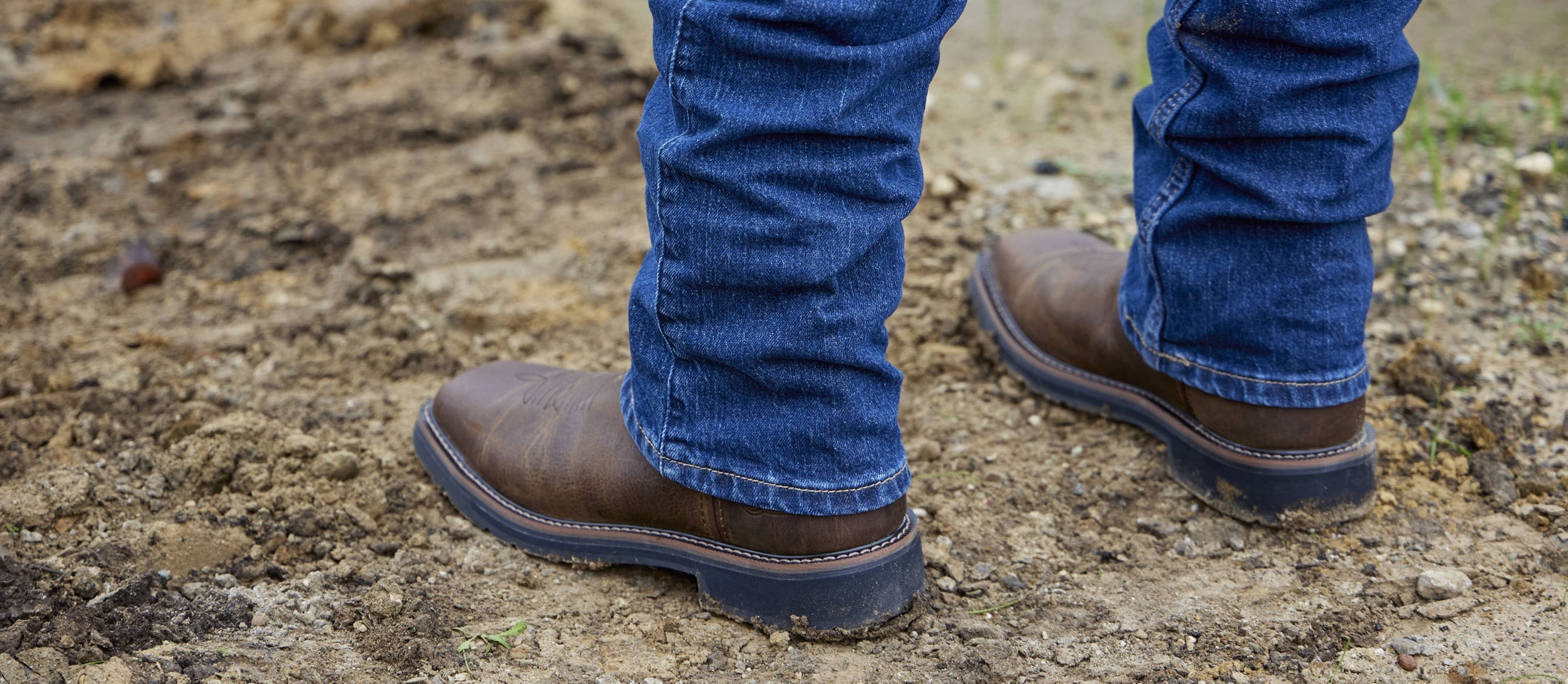 A man wearing Driller 11" Waterproof Steel Toe boot in brown.