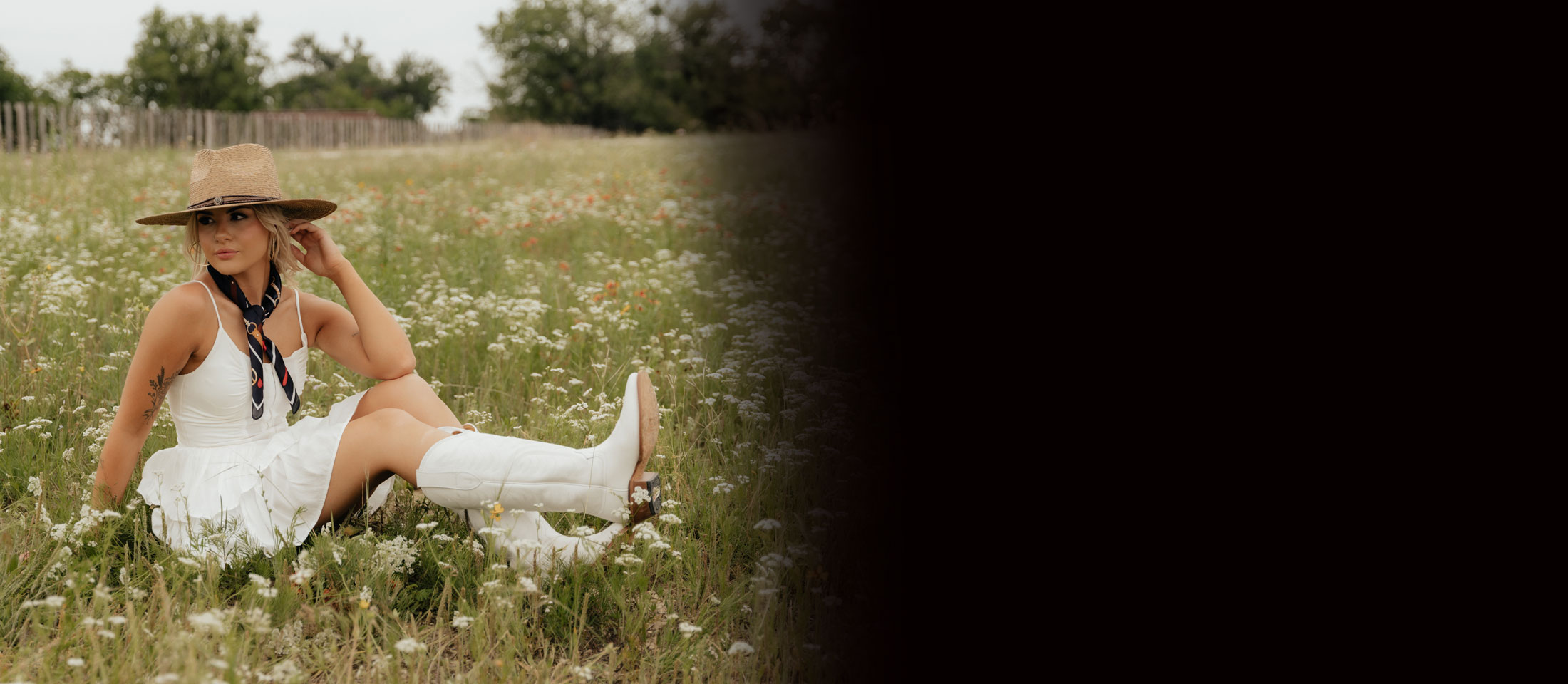 A woman wearing the 13” Women’s Evelyn Western boot in snow white.