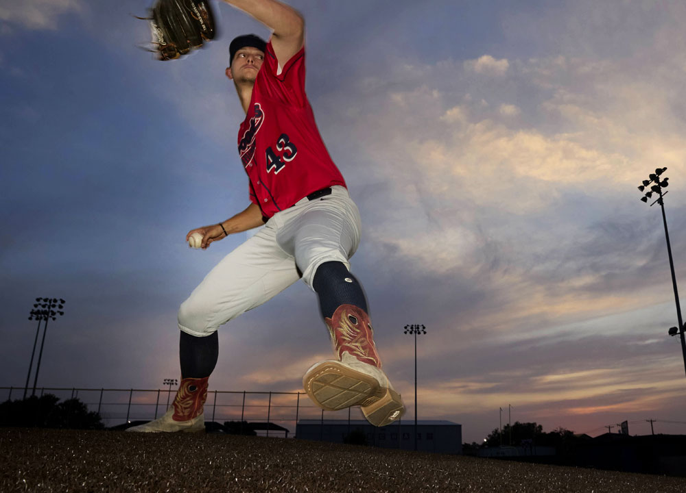 Men’s Pickett 11” western boot in grey and red, worn by a baseball player throwing a baseball on the baseball field.