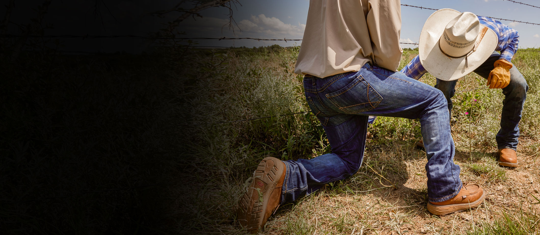 Two guys wearing men’s Rush 6” waterproof wedge in brown and a straw cowboy hat, fixing a fence. 