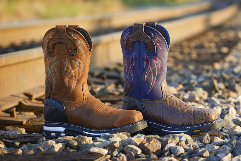Men’s Frontline HiViz 11” Waterproof Nano Comp Toe in brown posed by a railroad track.