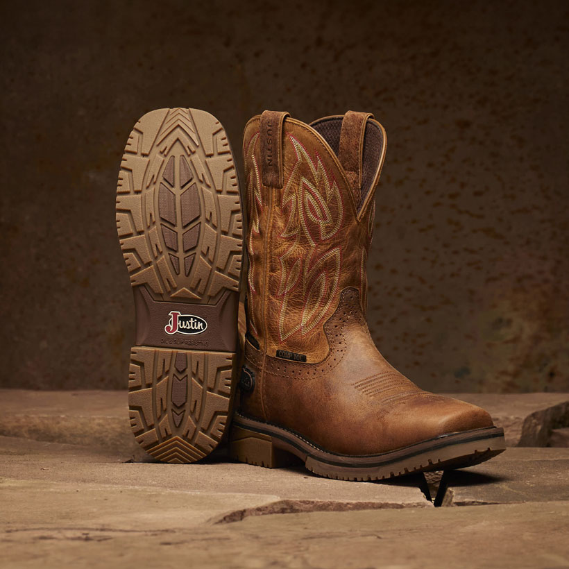 Men’s Wolfe 11” Nano Comp Toe boots in brown, posed showcasing the bottom of one boot. 