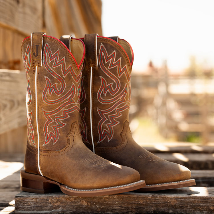 Women’s Little Sugar 11” Western boot in tan on a wooden bridge.