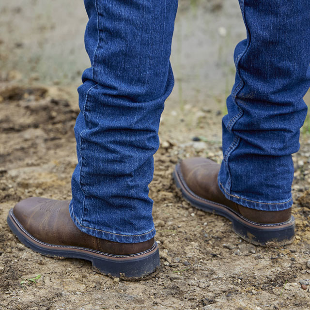 A man wearing Driller 11" Waterproof Steel Toe boot in brown.