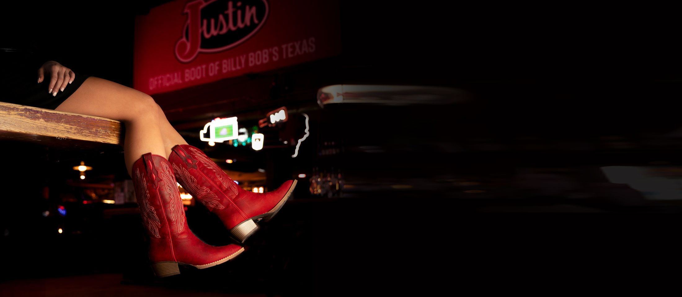 Women’s Renie 12” Western boot in red, worn by a woman leaning over the pool table. 