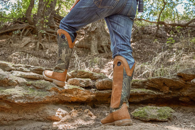 Men’s Rush Strike 17” Snake Resisting boots being worn by a man walking on rocks.